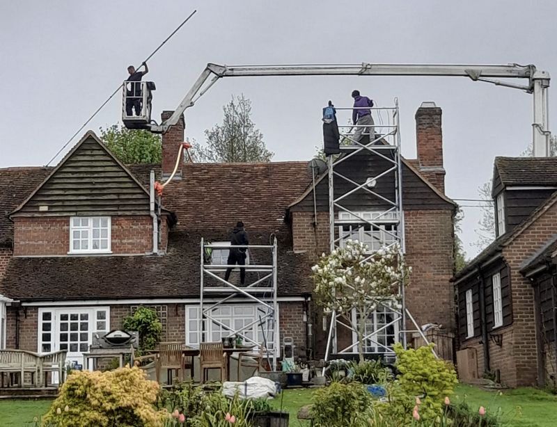 The Roof Moss Cleaners using cherry picker and scaffolding to clean roof safely and professionally in Basingstoke, Hampshire